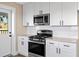 Kitchen featuring white cabinets, stainless steel appliances, and modern finishes at 6430 Russo Rd, Bartow, FL 33830