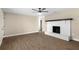 Living room with wood floors, ceiling fan, and a brick fireplace at 6430 Russo Rd, Bartow, FL 33830