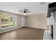 Bright and airy living room featuring wood floors, natural light, and a fireplace at 6430 Russo Rd, Bartow, FL 33830