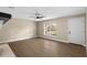 Bright living room with wood floors, neutral walls, a ceiling fan and large window at 6430 Russo Rd, Bartow, FL 33830
