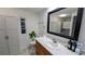 Bathroom featuring modern fixtures, clean vanity, sleek mirror, and good storage at 6450 Hollyberry Ne Ln, Winter Haven, FL 33881