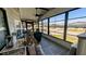 Enclosed porch with stone-like flooring and windows showing exterior community view at 6450 Hollyberry Ne Ln, Winter Haven, FL 33881