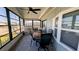 A cozy screened porch with comfortable seating, ceiling fan and nice flooring at 6450 Hollyberry Ne Ln, Winter Haven, FL 33881