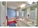 Bathroom featuring double sinks, neutral tile flooring, and tub shower combination at 6510 Oak Hammock Ln, Winter Haven, FL 33884