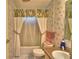 Bathroom featuring neutral tile flooring, tub shower combination, and single sink at 6510 Oak Hammock Ln, Winter Haven, FL 33884