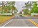 Community entrance with lush landscaping, sign and guard house, creating a welcoming atmosphere at 6510 Oak Hammock Ln, Winter Haven, FL 33884