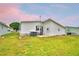 Exterior showcasing the backyard, siding, and manicured lawn of this cozy home at 6510 Oak Hammock Ln, Winter Haven, FL 33884