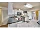 Functional kitchen with black countertops, white cabinetry, and updated appliances at 6510 Oak Hammock Ln, Winter Haven, FL 33884