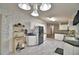 Open kitchen space with white cabinets, stone-look flooring, and view into living space at 6510 Oak Hammock Ln, Winter Haven, FL 33884