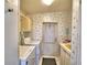 Well-lit laundry room with a washer, dryer, storage cabinets, and access to the outside at 6510 Oak Hammock Ln, Winter Haven, FL 33884
