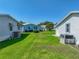 View of grassy area between homes showcasing well-kept lawns and pleasant neighborhood ambiance at 6603 Scenic Point Se Dr, Winter Haven, FL 33884