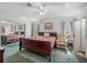 A Primary bedroom features a spacious layout, soft carpeting, and a ceiling fan at 6603 Scenic Point Se Dr, Winter Haven, FL 33884