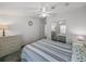 This bedroom offers mirrored closet doors, a ceiling fan, and a soothing color palette for restful relaxation at 6603 Scenic Point Se Dr, Winter Haven, FL 33884