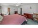 This bedroom features a ceiling fan, comfortable carpeting, and soft, natural light at 6603 Scenic Point Se Dr, Winter Haven, FL 33884