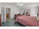 This bedroom features a ceiling fan, comfortable carpeting, and soft, natural light at 6603 Scenic Point Se Dr, Winter Haven, FL 33884