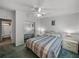Bright bedroom featuring mirrored closet doors, a ceiling fan, and an ensuite bathroom for added privacy at 6603 Scenic Point Se Dr, Winter Haven, FL 33884