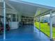 Covered carport with an electric golf cart and view of the enclosed lanai at 6603 Scenic Point Se Dr, Winter Haven, FL 33884