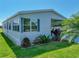 Single-story home with manicured lawn, partial carport, and meticulous landscaping at 6603 Scenic Point Se Dr, Winter Haven, FL 33884