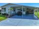 Charming home featuring a covered carport, an enclosed lanai and well-maintained landscaping at 6603 Scenic Point Se Dr, Winter Haven, FL 33884