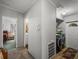 Hallway leading to laundry area, bathroom and bedroom with neutral-toned walls and carpeting at 6603 Scenic Point Se Dr, Winter Haven, FL 33884
