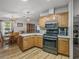 An open kitchen features wood cabinets, stainless steel appliances, and an adjacent dining area at 6603 Scenic Point Se Dr, Winter Haven, FL 33884