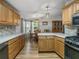 A spacious kitchen with wooden cabinets and modern appliances leads to a cozy dining area at 6603 Scenic Point Se Dr, Winter Haven, FL 33884