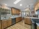 Well-lit kitchen boasts wood cabinets, modern appliances, and a decorative backsplash at 6603 Scenic Point Se Dr, Winter Haven, FL 33884