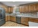 Bright kitchen featuring wooden cabinetry, stainless steel appliances, and a stone-look backsplash at 6603 Scenic Point Se Dr, Winter Haven, FL 33884
