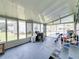 Bright sunroom with plenty of natural light, outdoor views, and comfortable seating arrangement at 6603 Scenic Point Se Dr, Winter Haven, FL 33884