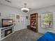Cozy living room with plush carpet, ample lighting, and a decorative shelving unit at 6603 Scenic Point Se Dr, Winter Haven, FL 33884