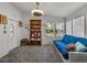 Bright living room with a comfortable blue futon and a view of the outdoors at 6603 Scenic Point Se Dr, Winter Haven, FL 33884