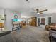 Expansive living area offering multiple seating areas, an entertainment center, and an adjacent dining room at 6603 Scenic Point Se Dr, Winter Haven, FL 33884