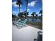 Lounge chairs set around a tranquil pond at the community pool area on a sunny day at 6603 Scenic Point Se Dr, Winter Haven, FL 33884