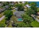 Aerial view of the property featuring a screened pool and mature trees at 6754 Winterset Gardens Rd, Winter Haven, FL 33884