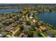 An aerial view shows a charming neighborhood with a home featuring a pool and backyard at 6754 Winterset Gardens Rd, Winter Haven, FL 33884