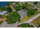 Aerial view of property featuring mature trees, green lawns, and lush landscaping at 6754 Winterset Gardens Rd, Winter Haven, FL 33884