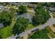 Aerial view of property featuring mature trees, green lawns, and lush landscaping at 6754 Winterset Gardens Rd, Winter Haven, FL 33884