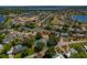 Aerial view of a charming neighborhood with a home featuring a pool and lush landscaping at 6754 Winterset Gardens Rd, Winter Haven, FL 33884