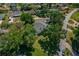 Aerial view of property featuring mature trees, green lawns, and lush landscaping at 6754 Winterset Gardens Rd, Winter Haven, FL 33884