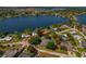 Aerial shot showing a lakefront neighborhood and the house with its mature trees at 6754 Winterset Gardens Rd, Winter Haven, FL 33884