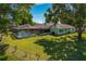 A lovely screened pool area and lush green lawn create an outdoor oasis at 6754 Winterset Gardens Rd, Winter Haven, FL 33884