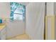 Bathroom featuring tiled walls, a shower with a curtain, and a window for natural light at 6754 Winterset Gardens Rd, Winter Haven, FL 33884