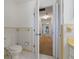Bathroom with toilet and a glimpse of the hallway, showcasing the home's interior layout at 6754 Winterset Gardens Rd, Winter Haven, FL 33884