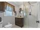 Bathroom boasts a stand-up shower, and a dark wood vanity and cabinets at 6754 Winterset Gardens Rd, Winter Haven, FL 33884