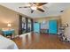 Primary bedroom features wood floors, a ceiling fan, and two dressers at 6754 Winterset Gardens Rd, Winter Haven, FL 33884
