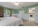 Bright bedroom with a laundry room view, neutral carpet, and white baseboards at 6754 Winterset Gardens Rd, Winter Haven, FL 33884