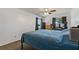 Cozy bedroom featuring a ceiling fan, neutral walls, and a comfortable blue bedspread at 6754 Winterset Gardens Rd, Winter Haven, FL 33884