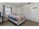 Bedroom with double closet, window, bedside table and carpet flooring for a comfortable space at 6754 Winterset Gardens Rd, Winter Haven, FL 33884