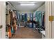 Walk-in closet with wood floors, metal shelving, and plenty of storage space at 6754 Winterset Gardens Rd, Winter Haven, FL 33884