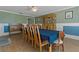 Traditional dining room with wood floors, a blue tablecloth, and a wood china cabinet at 6754 Winterset Gardens Rd, Winter Haven, FL 33884